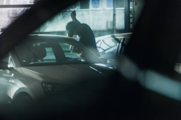 istock Assaulter breaking a car door 1361898771