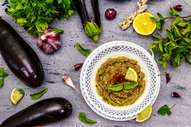 istock Eggplant dip baba ganoush (mutabbal) or mezze with ripe vegetables and fresh herbs 1361900497