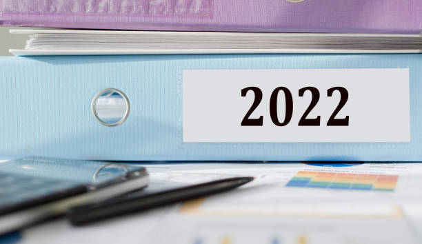 istock Blue office folder with 2022 text on the office table with other documents and a black pen 1361902364