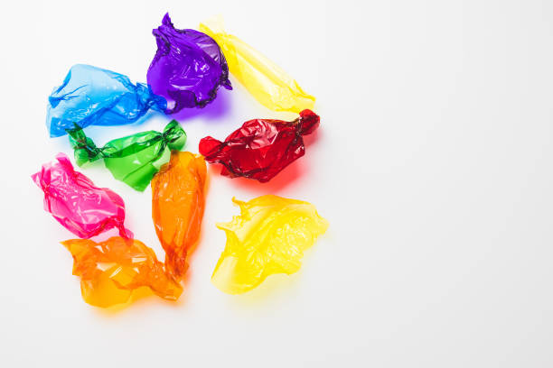 istock Colorful candy wrappers on white background, copy space 1361902597