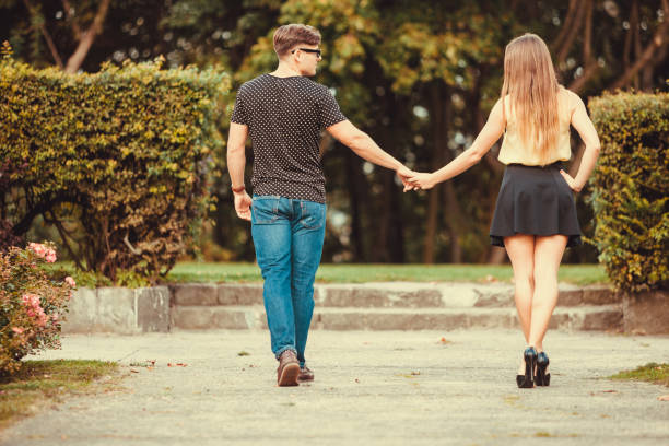 istock Couple in park taking walk. 1361903738
