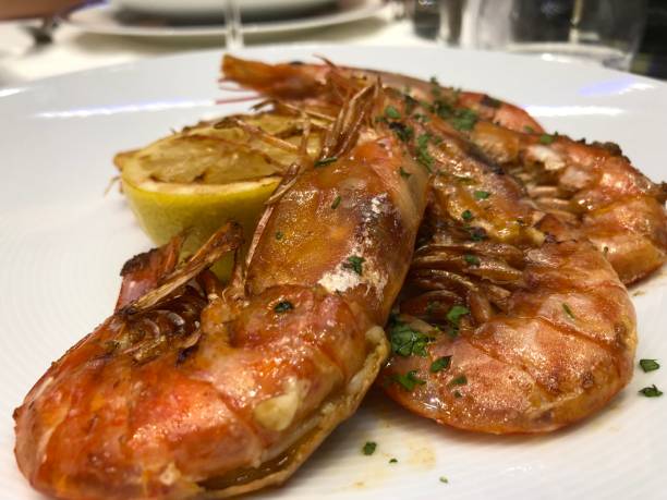 istock Gourmet cuisine with grilled prawns and lemon 1361904107
