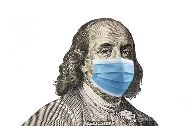 Benjamin Franklin wearing a protective mask on white background, Coronavirus Affects the USA And Global Stock Market Concept