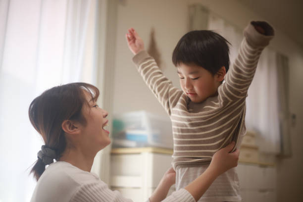 istock Mother dressing her child 1361907911