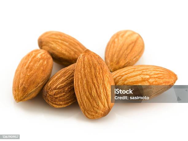 A Pile Of 6 Raw Almonds On A White Background Stock Photo - Download Image Now - Almond, Brown, Close-up