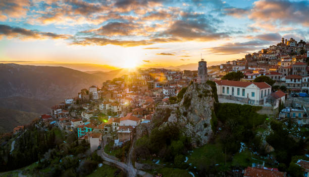 Panoramic sunset aerial view of the mountain village Arachova Panoramic aerial view of the mountain village Arachova, Boiotia, Greece, tourist resort for ski and trekking sports during a golden winter sunset arachova greece stock pictures, royalty-free photos & images