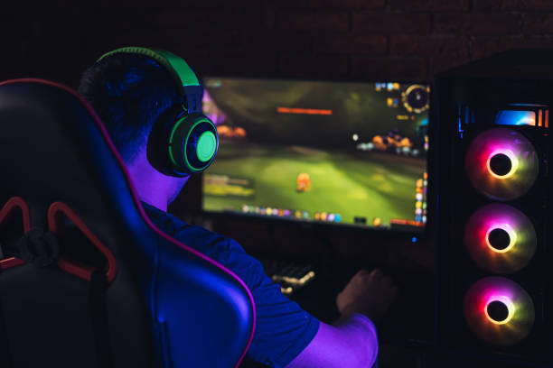 istock The guy plays video games and streams on the computer under neon light 1361910995