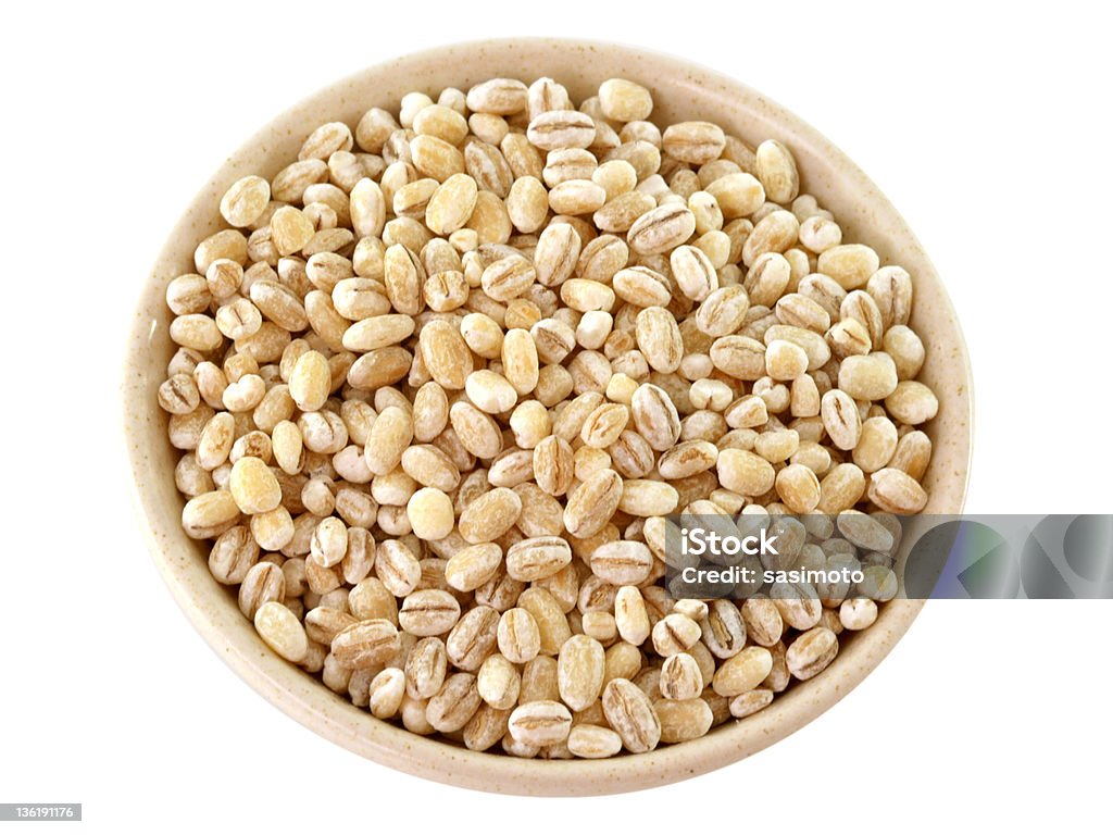 Barley in a bowl, isolated on white Barley ..lowering cholesterol, activates immune functioning. Great source of potassium, magnesium, niacin and chromium.  Agriculture Stock Photo