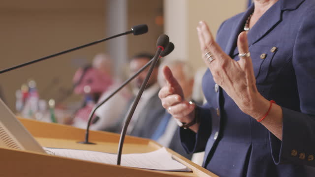 Hands of Female Politician Gesticulating during Speech at Conference