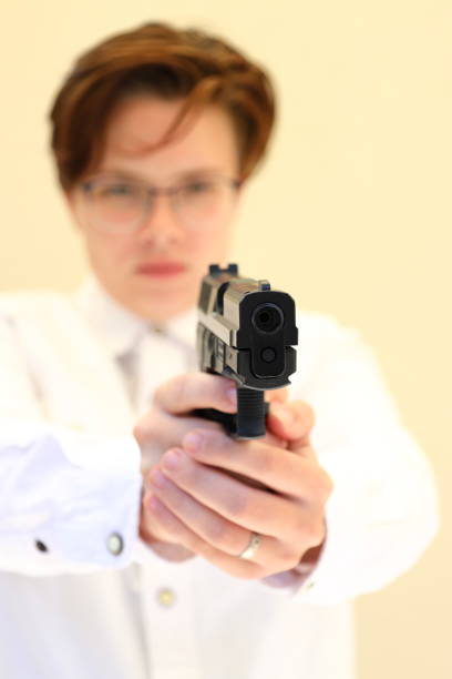 istock A young caucasian woman aiming a pistol. 1361912785