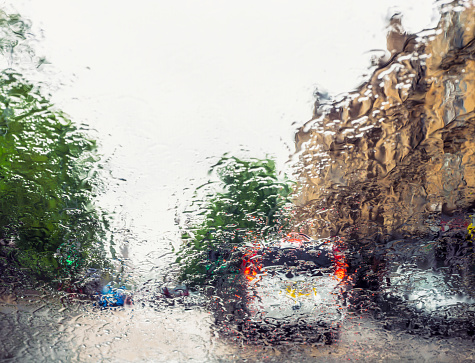 A view through a windscreen covered in rain to a street in Glasgow, Scotland.