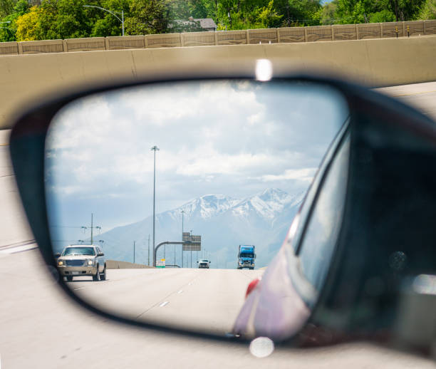 istock Checking car's mirror on interstate journey 1361912861