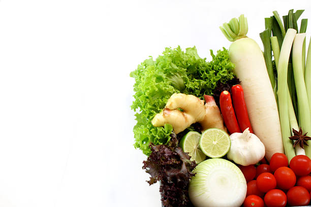 Ingredients for Italian vegetable soup. Celery, tomatoes, onions and carrots, cauliflower and garlic, zucchini on a stone table.
