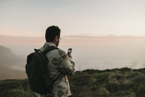 istock Man taking a picture of a beautiful landscape 1361914794