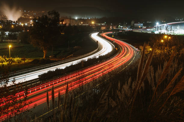 istock Light trails of a highway at night 1361914830