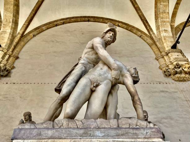 the gentle holding of pratroclus - a marble statue located in the open-air gallery loggia dei lanzi on the piazza della signoria florence, tuscany, italy. - loggia dei lanzi imagens e fotografias de stock