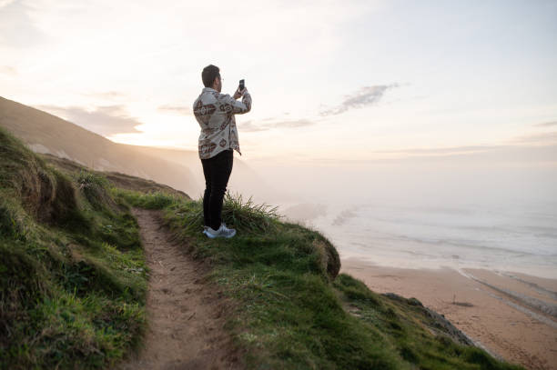 istock Man taking a picture of a beautiful landscape 1361914902