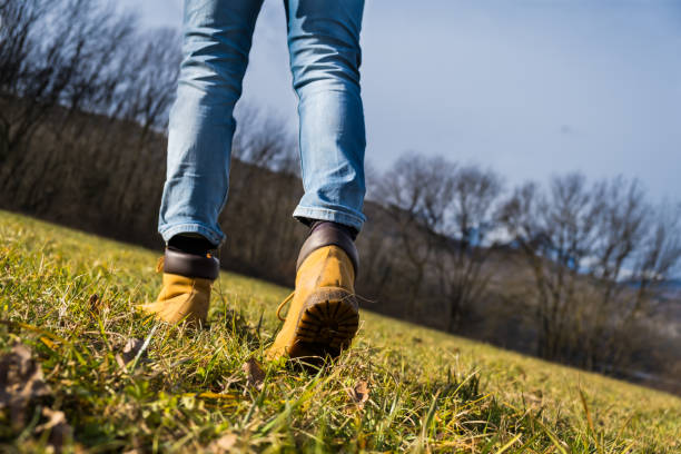 istock Hikers muddy boots on forest hiking trail. copy space 1361915947