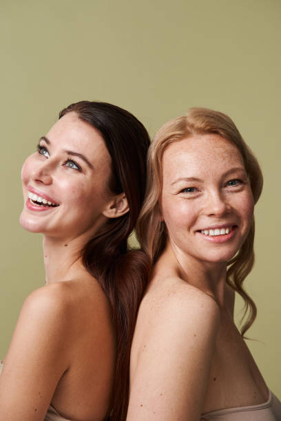 istock Laughing vivacious diverse women with a beaming smiles posing back to back 1361916061