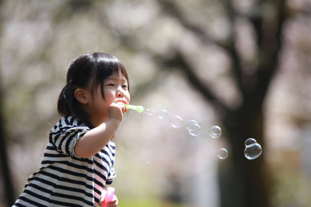 Girl playing with soap bubbles