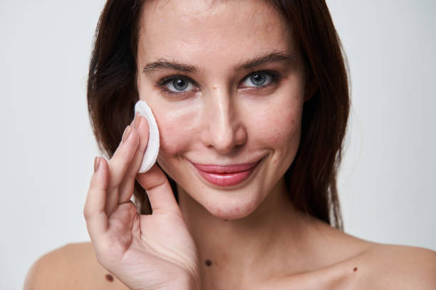 istock Beautiful girl with acne problem skin removing makeup after long day 1361919089