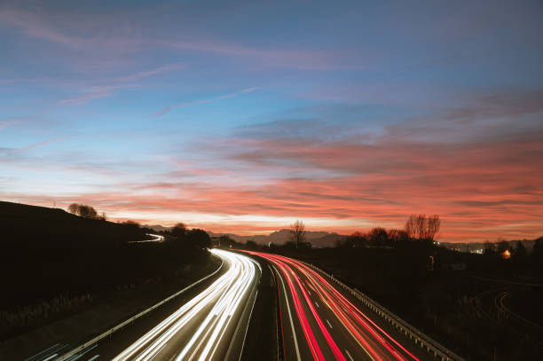 istock Light trails of a highway at sunset 1361919307