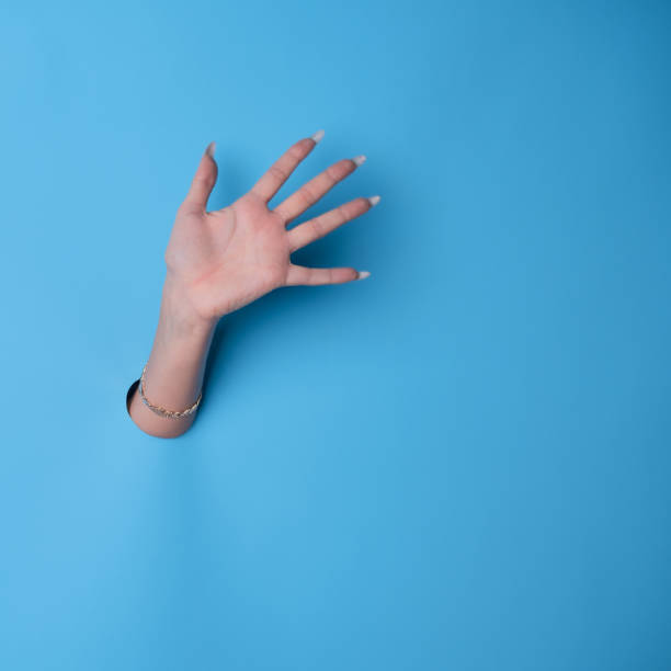istock A greeting, a wave, or a high five. A beautiful female hand with a manicure 1361919345