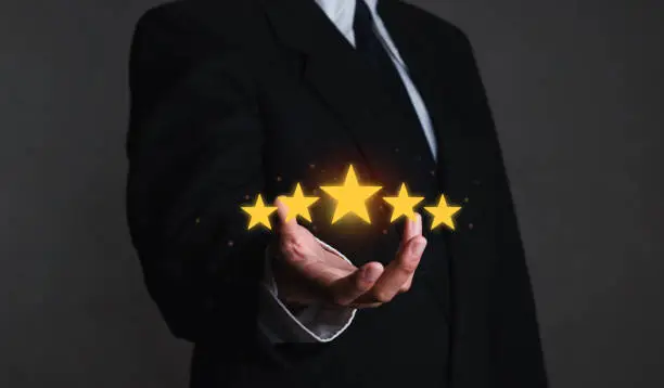 Photo of Hand of the head of the company who gave the customer a five-star rating. with copy space five star rating service rating concept of satisfaction