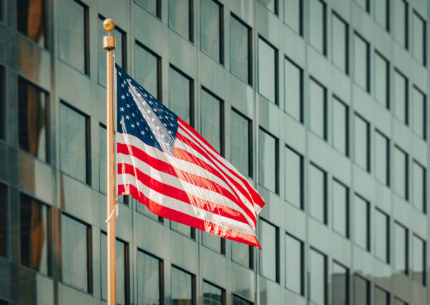 istock USA flag and modern building 1361923364