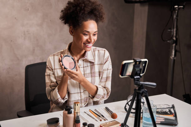 istock Multiracial woman professional beauty blogger recording make up tutorial 1361925255