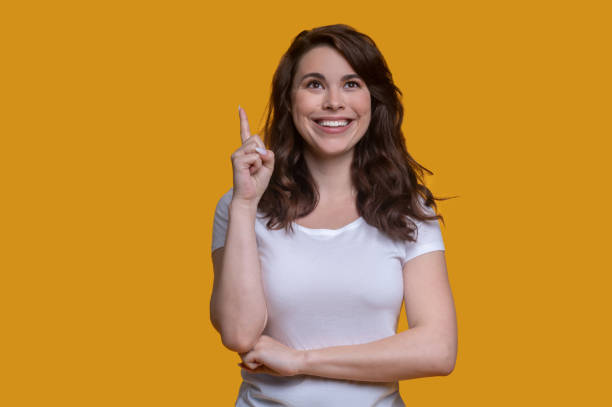 istock Cheerful female holding up her index finger 1361926137