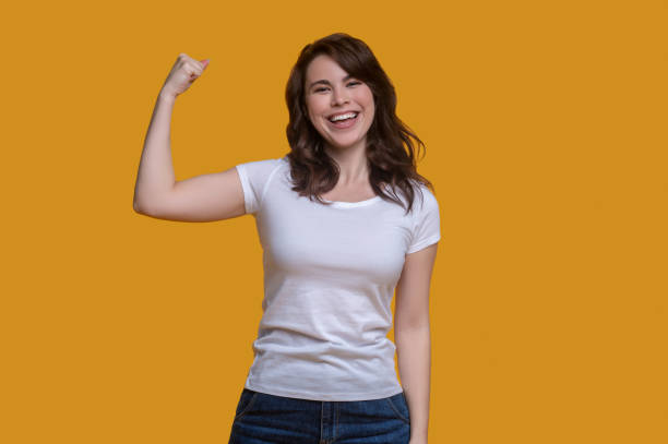istock Cheerful cute young woman demonstrating her strength 1361926149