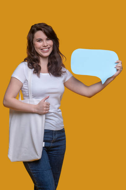 istock Joyful girl showing question sign before the camera 1361926315