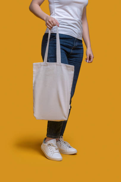 istock Female demonstrating her stylish bag before the camera 1361926504