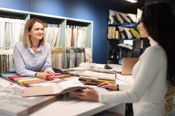 istock Woman consultant helping client choose curtains in workshop 1361928462