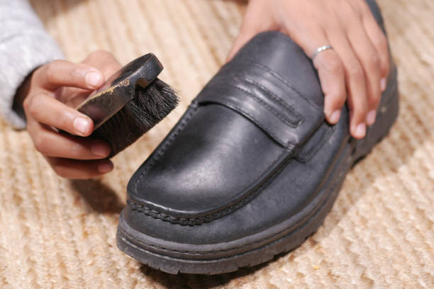 istock cleaning Shoe with a brush on floor 1361929967
