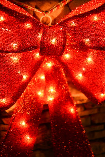 Red Bow with Lights Christmas Decoration steven harrie stock pictures, royalty-free photos & images
