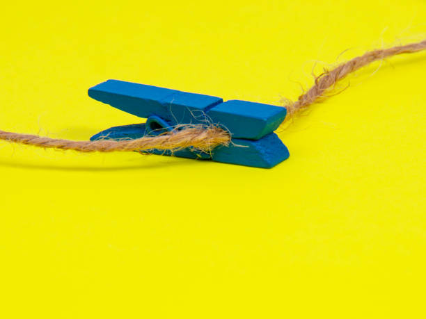 istock Clothes pins wooden on yellow background decorative 1361932360