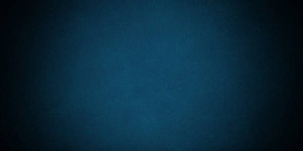 istock Dark blue background texture with black vignette in old vintage grunge textured border design, dark elegant teal color wall with light spotlight center 1361932378