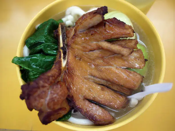 Photo of close-up view of xiao long bao dumpling filling with juicy pork  in Bamboo Steamer Basket chinese signature famous menu