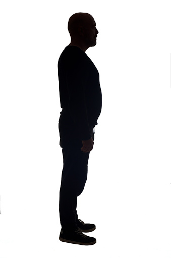 side view of the silhouette of a man wearing casual