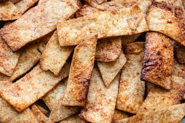 A pile of crispy baked cinnamon sugar tortilla chips