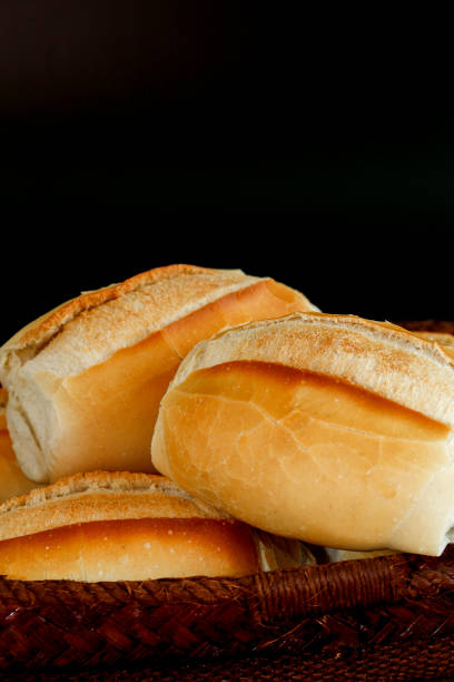 istock Portion of french bread on black background 1361940207