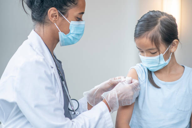 istock Doctor Bandaging After a Vaccine 1361943407
