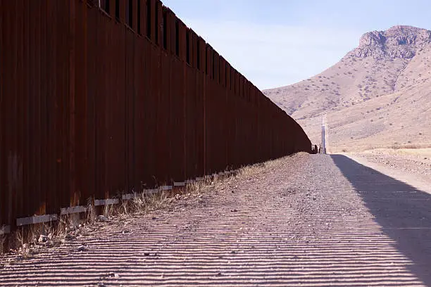 Image of the fence separating the Mexican and American border.  Taken in Southern Arizona.