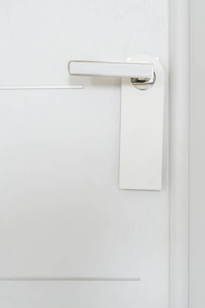 istock Hotel room door with blank sign on the handle 1361952459