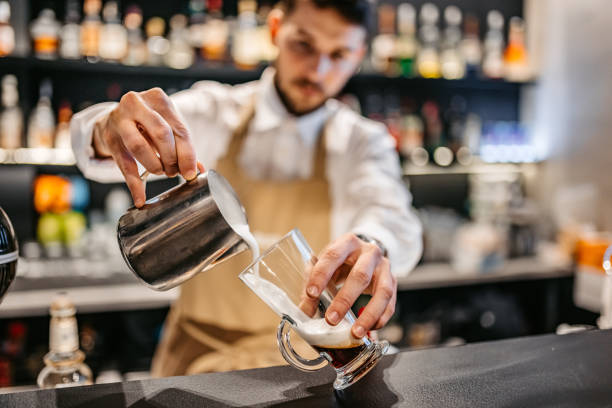 Bartender making Frappuccino with whipped cream