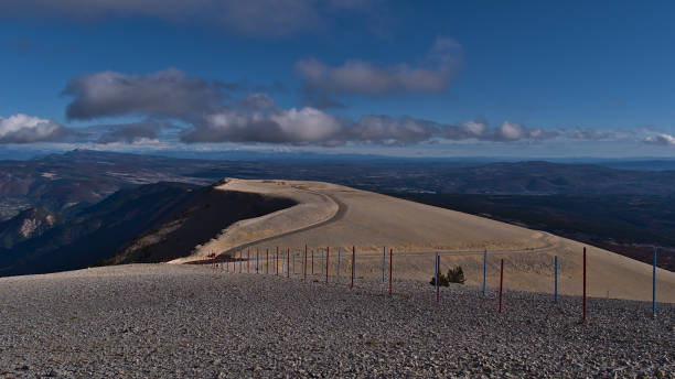 View of the bare top of Mont Ventoux, popular for cycling and skiing, with white limestone rocks in Provence, France with view over the French Prealps on sunny day in autumn. View of the bare top of Mont Ventoux, popular for cycling and skiing, with white limestone rocks in Provence region, France with panoramic view over the French Prealps on sunny day in autumn. mistral wind stock pictures, royalty-free photos & images