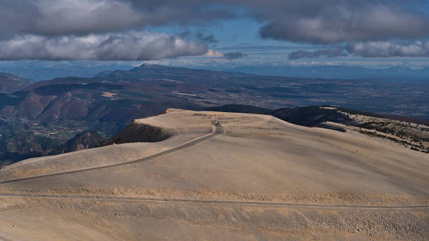 Panoramic view of the bare peak of Mont Ventoux, popular for cycling and skiing, with white limestone rocks in Provence, France on sunny day in autumn with cloudy sky. Panoramic view of the bare peak of Mont Ventoux, popular for cycling and skiing, with white limestone rocks in Provence region, France on sunny day in autumn season with cloudy sky. mistral wind stock pictures, royalty-free photos & images
