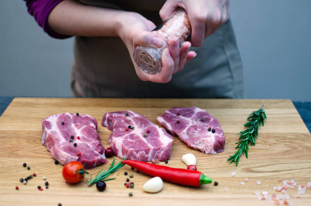 istock Chef hands cooking meat steak and adding salt and pepper on black copy space background for menu restaurant or recipe text 1361965663
